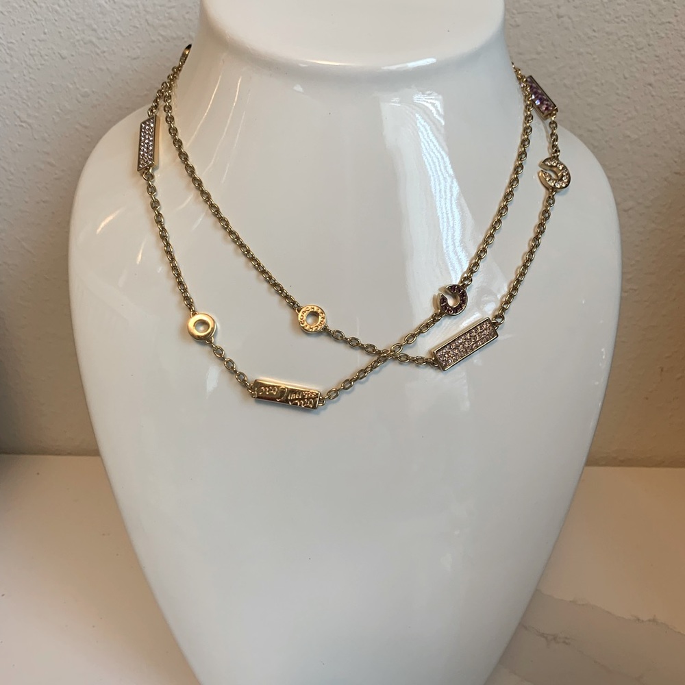 COACH Signature Gold Necklace with pink and clear stones.